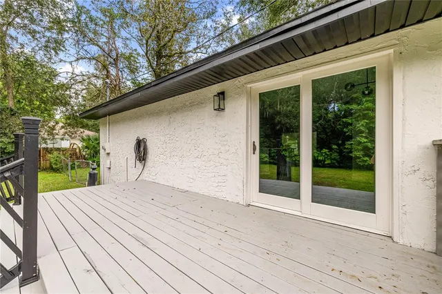 a view of a terrace with yard and sitting area