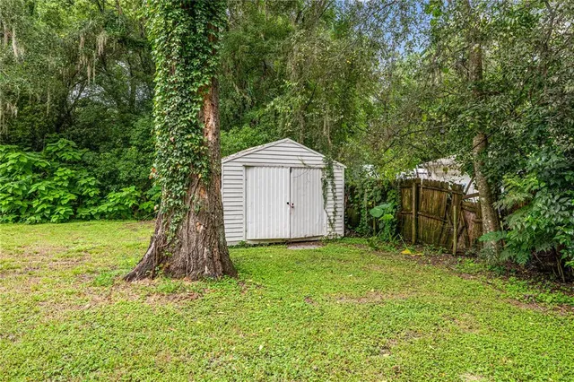 a view of a house with backyard and sitting area