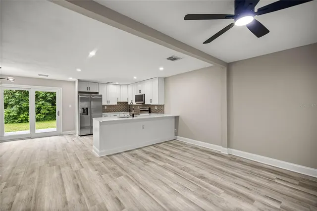 a view of kitchen with cabinets and outdoor space