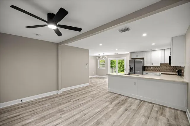 a kitchen with stainless steel appliances granite countertop a refrigerator and a stove top oven