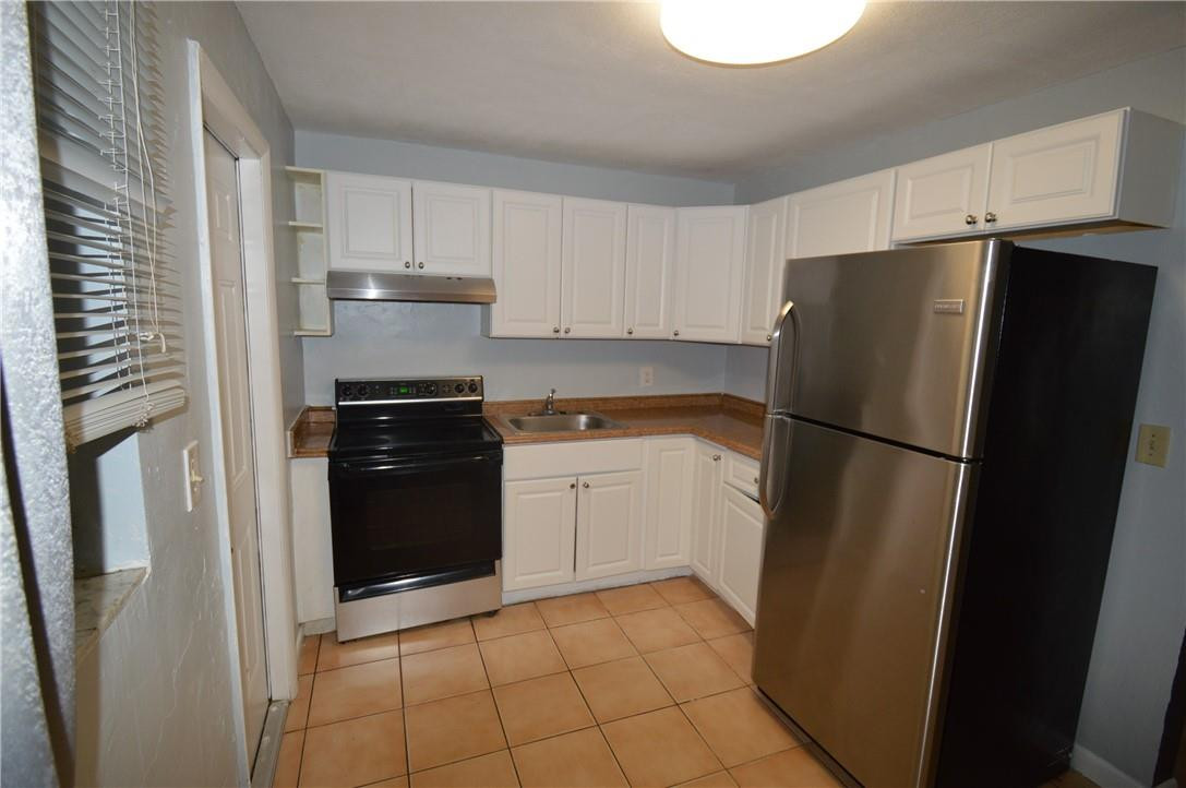 a kitchen with a refrigerator and a sink