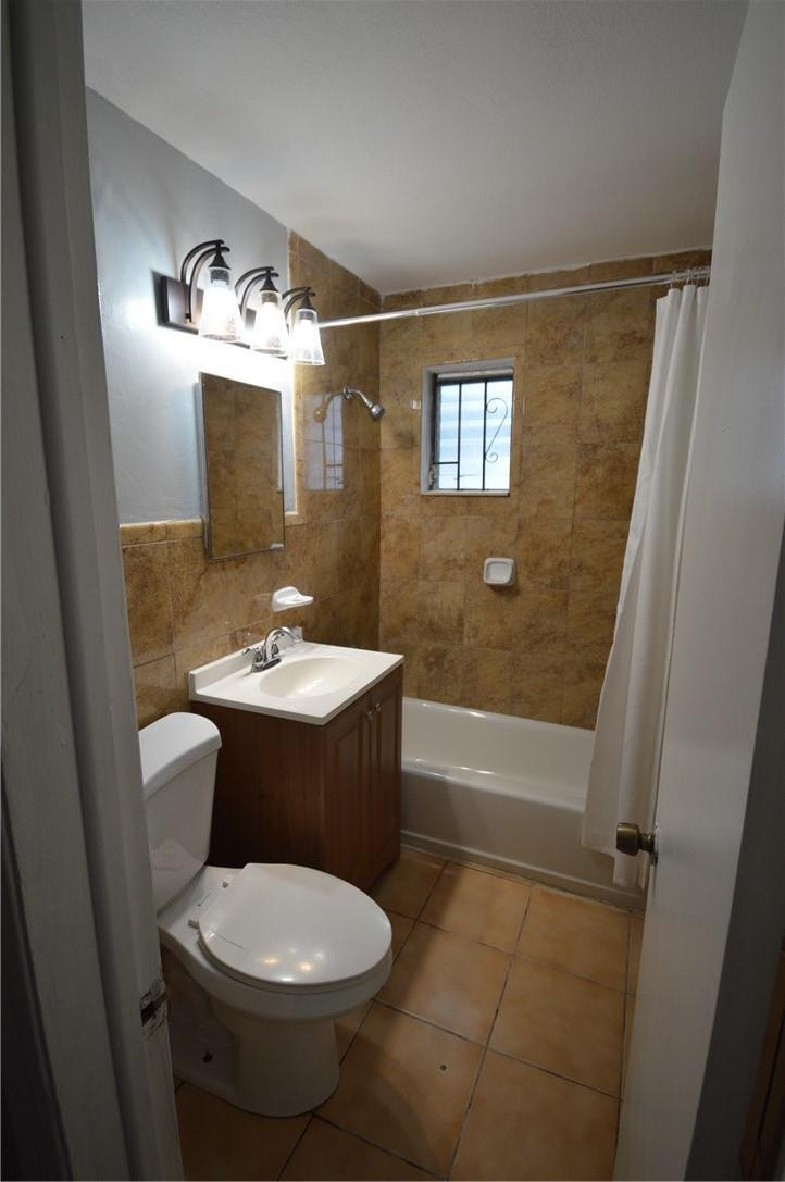 807 Phippen Waiters Road, Unit 1 Dania Beach, FL 33004 - Photo 4 of 6 a bathroom with a sink a toilet and shower