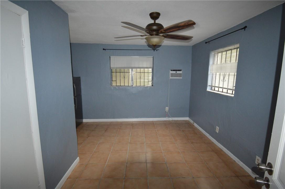 807 Phippen Waiters Road, Unit 1 Dania Beach, FL 33004 - Photo 6 of 6 a view of an empty room with a window