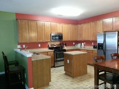 1109 Garrison Road Charlotte, NC 28262 - Photo 2 of 22 a kitchen with a stove top oven a sink a counter top space and cabinets