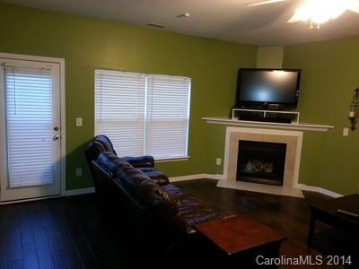1109 Garrison Road Charlotte, NC 28262 - Photo 6 of 22 a living room with furniture a flat screen tv and a fireplace