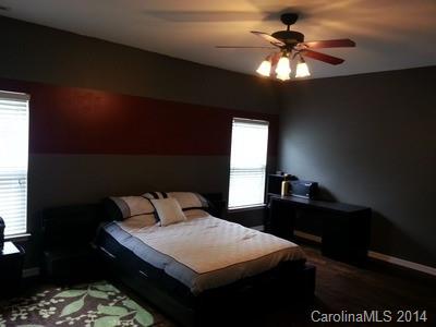 1109 Garrison Road Charlotte, NC 28262 - Photo 9 of 22 a bedroom with a bed and a chandelier