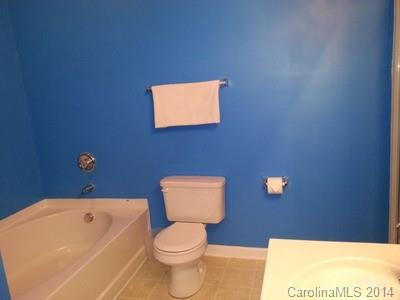 1109 Garrison Road Charlotte, NC 28262 - Photo 10 of 22 a bathroom with a toilet a sink and mirror