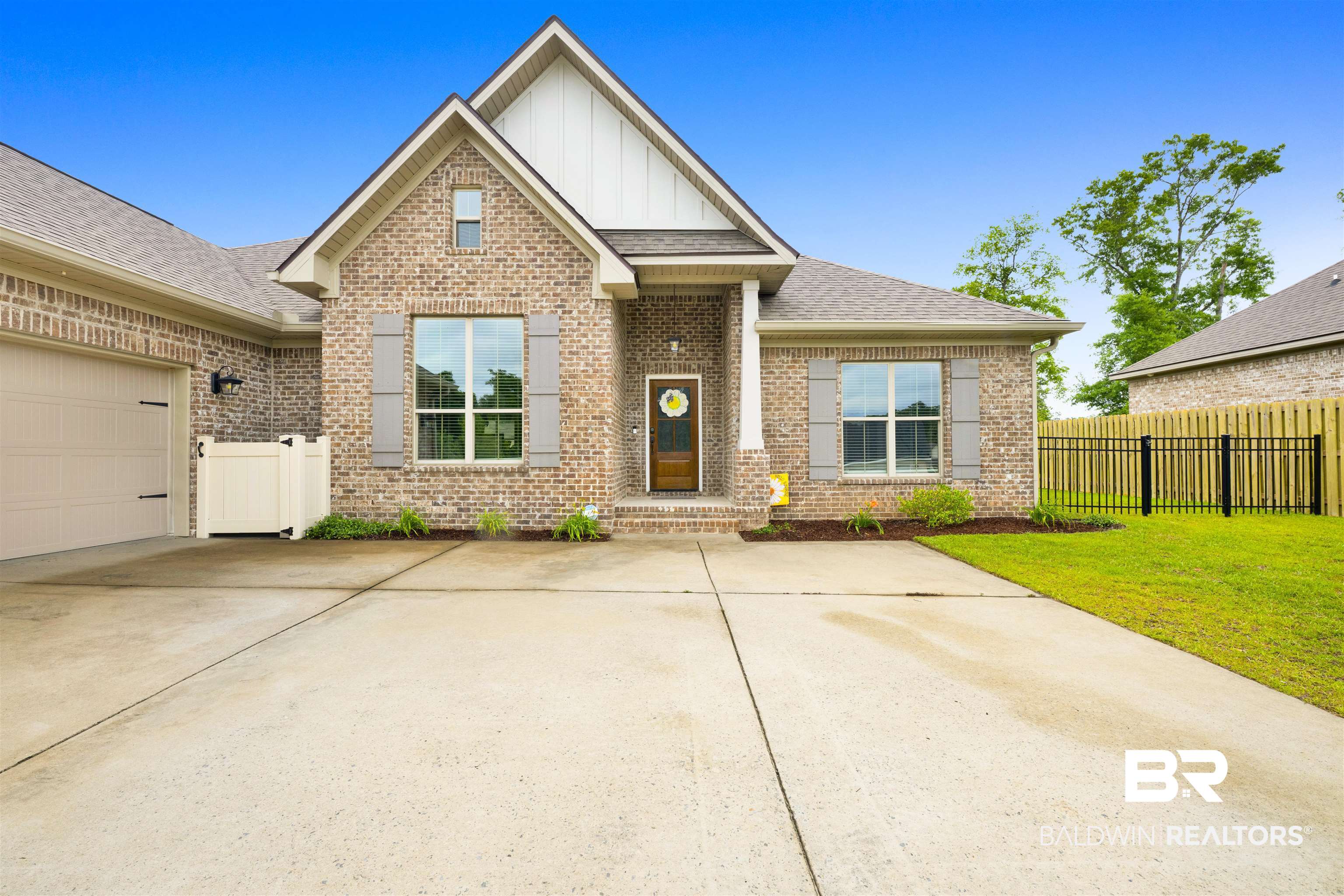 12672 Squirrel Drive Daphne, AL 36527 - Photo 2 of 49 Brick exterior featuring a gabled roofline, front-facing garage, and an extended concrete driveway