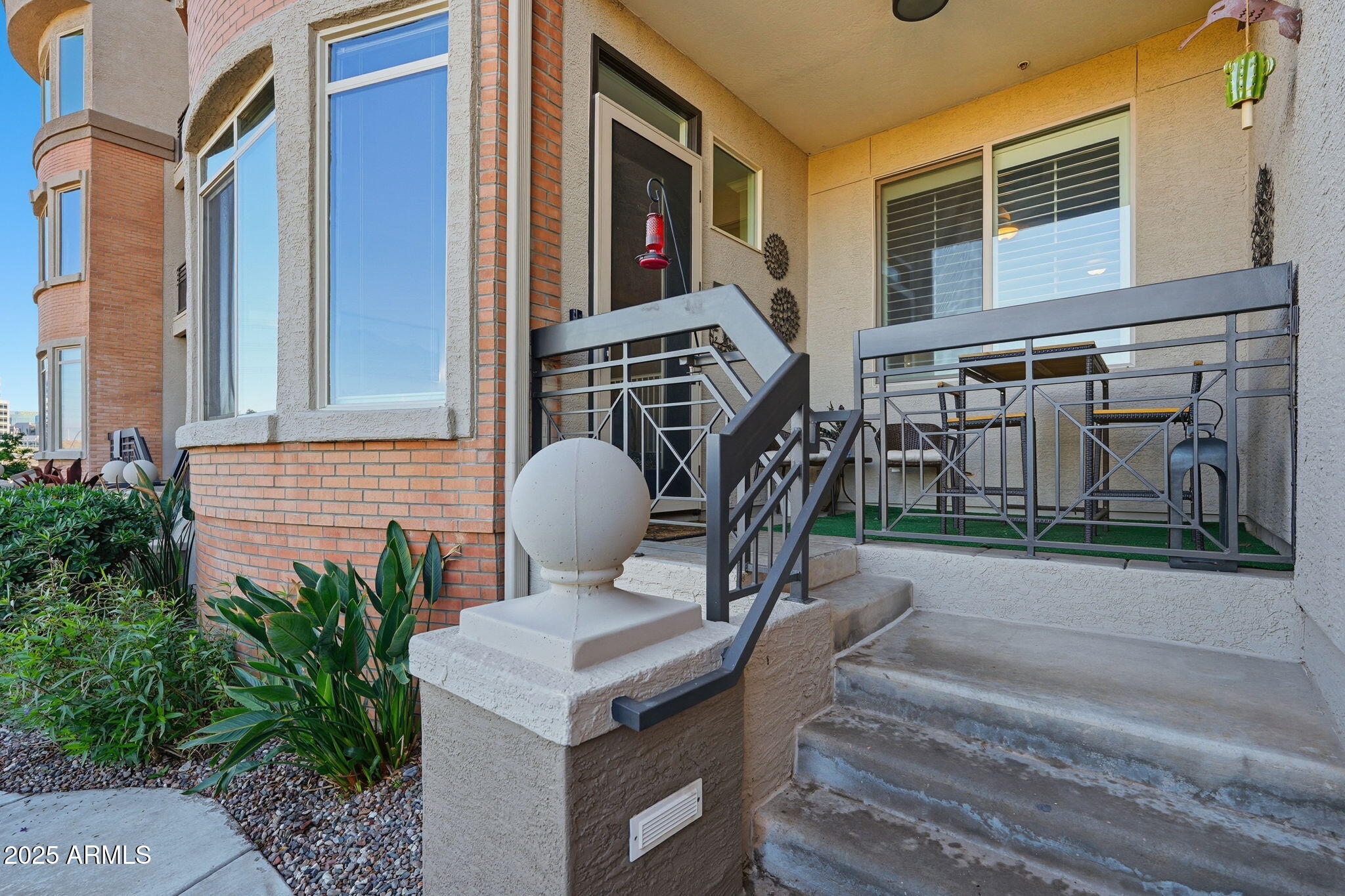 a backyard of a house with barbeque oven table and chairs