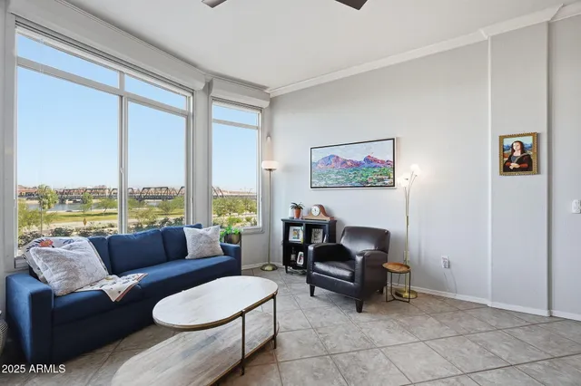a living room with furniture and a floor to ceiling window