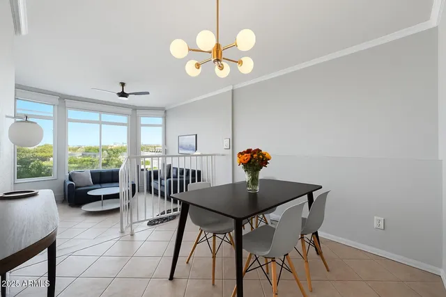 a view of a dining room with furniture and a large window