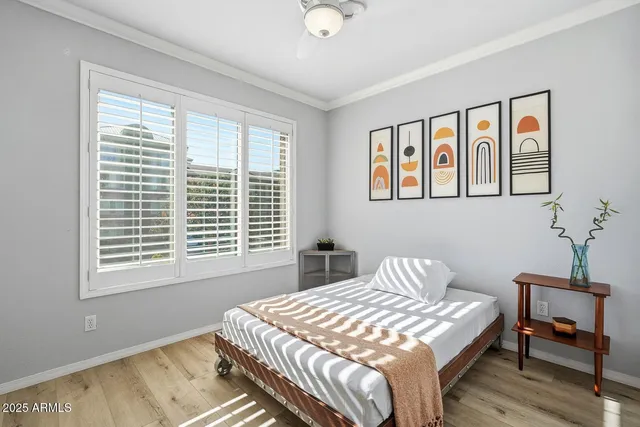 a bedroom with a bed and wooden floor