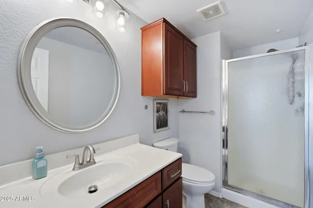 a bathroom with a sink a toilet and a mirror