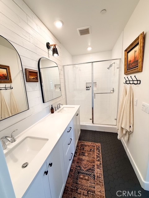 27628 Exploration Newhall, CA 91381 - Photo 11 of 15 a bathroom with double vanity sink and mirror