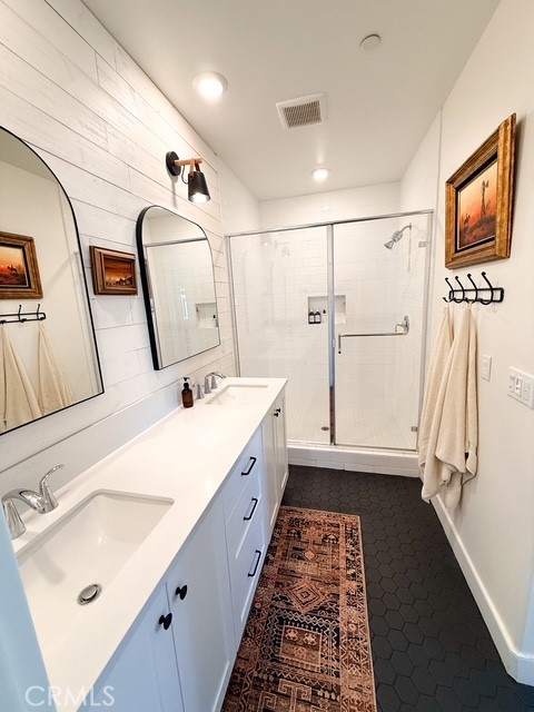 27628 Exploration Newhall, CA 91381 - Photo 12 of 15 a bathroom with double vanity sink and mirror
