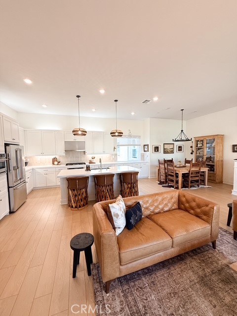 27628 Exploration Newhall, CA 91381 - Photo 3 of 15 a living room with stainless steel appliances kitchen island granite countertop furniture and a view of kitchen