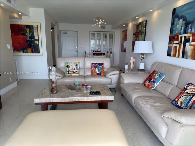 a living room with furniture and a book shelf