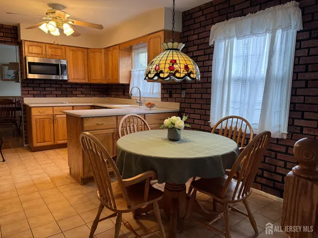 a view of a dining room with furniture and chandelier