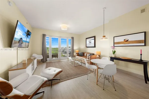 a living room with furniture and wooden floor