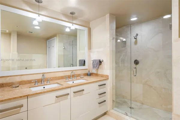 a bathroom with a shower sink double and mirror