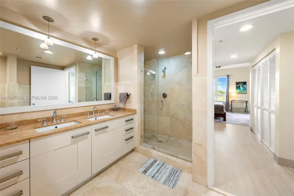 a bathroom with a shower sink and mirror