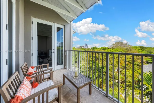 a balcony with an outdoor seating space