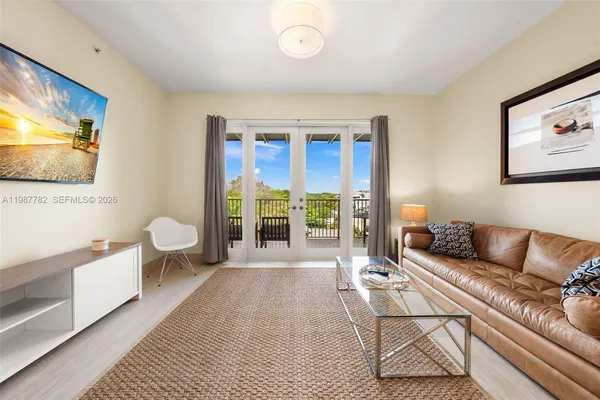 a living room with furniture and a flat screen tv