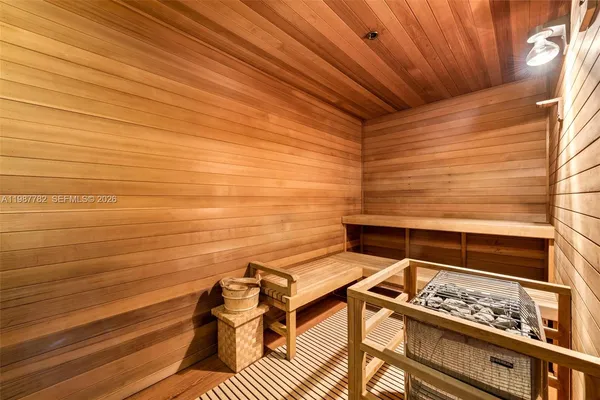 a view of roof deck with wooden floor and seating space