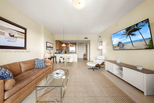 a living room with furniture and a wooden floor