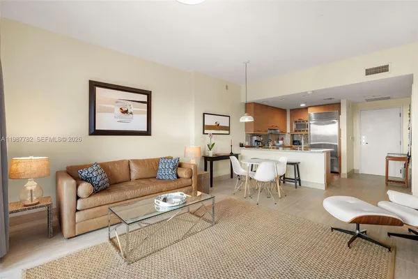 a living room with furniture a rug and a table