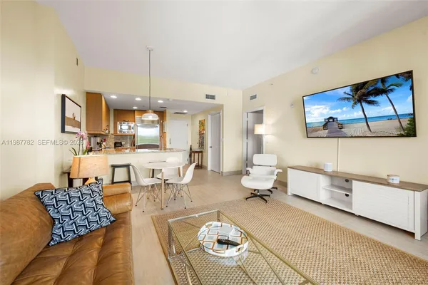 a living room with furniture a rug and white walls