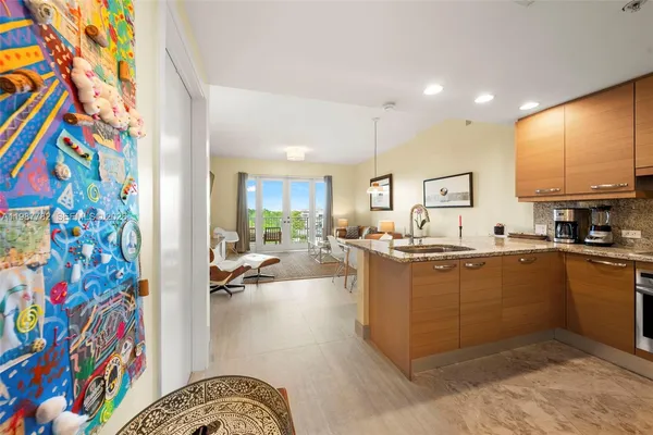 a kitchen with stainless steel appliances granite countertop a sink and counter top space