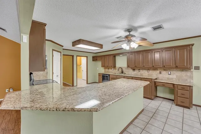 a kitchen with stainless steel appliances granite countertop a sink and cabinets