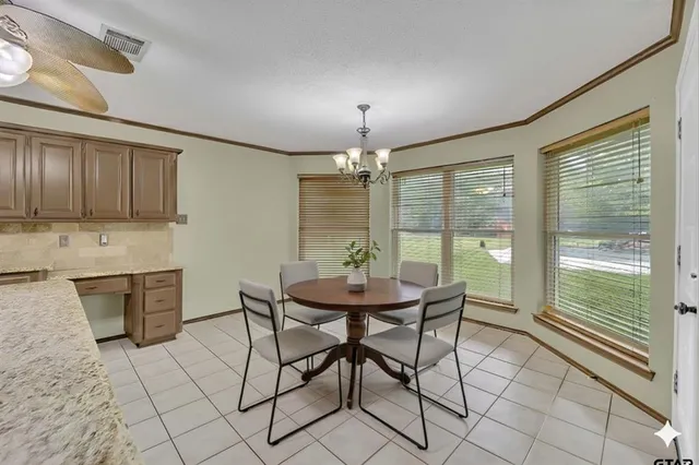 a view of a dining room with furniture window and outside view