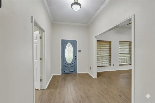 a view of a livingroom with wooden floor and window