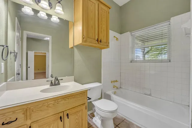 a bathroom with a sink a toilet and bathtub
