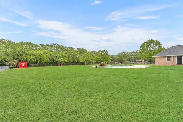 a green field with lots of tress in it