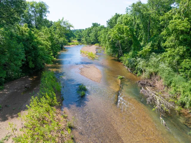 a view of a lake with beach and outdoor space