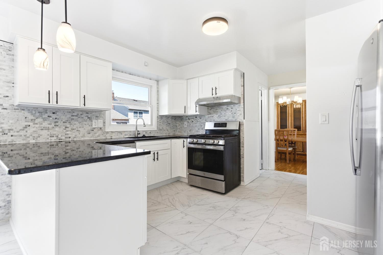 7 Oberlin Court Edison, NJ 08820 - Photo 12 of 45 a kitchen with stainless steel appliances granite countertop a stove sink and cabinets