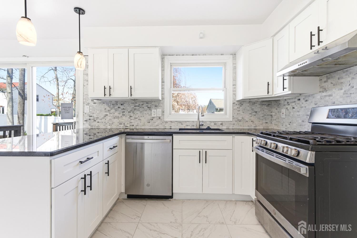 7 Oberlin Court Edison, NJ 08820 - Photo 15 of 45 a kitchen with granite countertop white cabinets white appliances with a sink and dishwasher