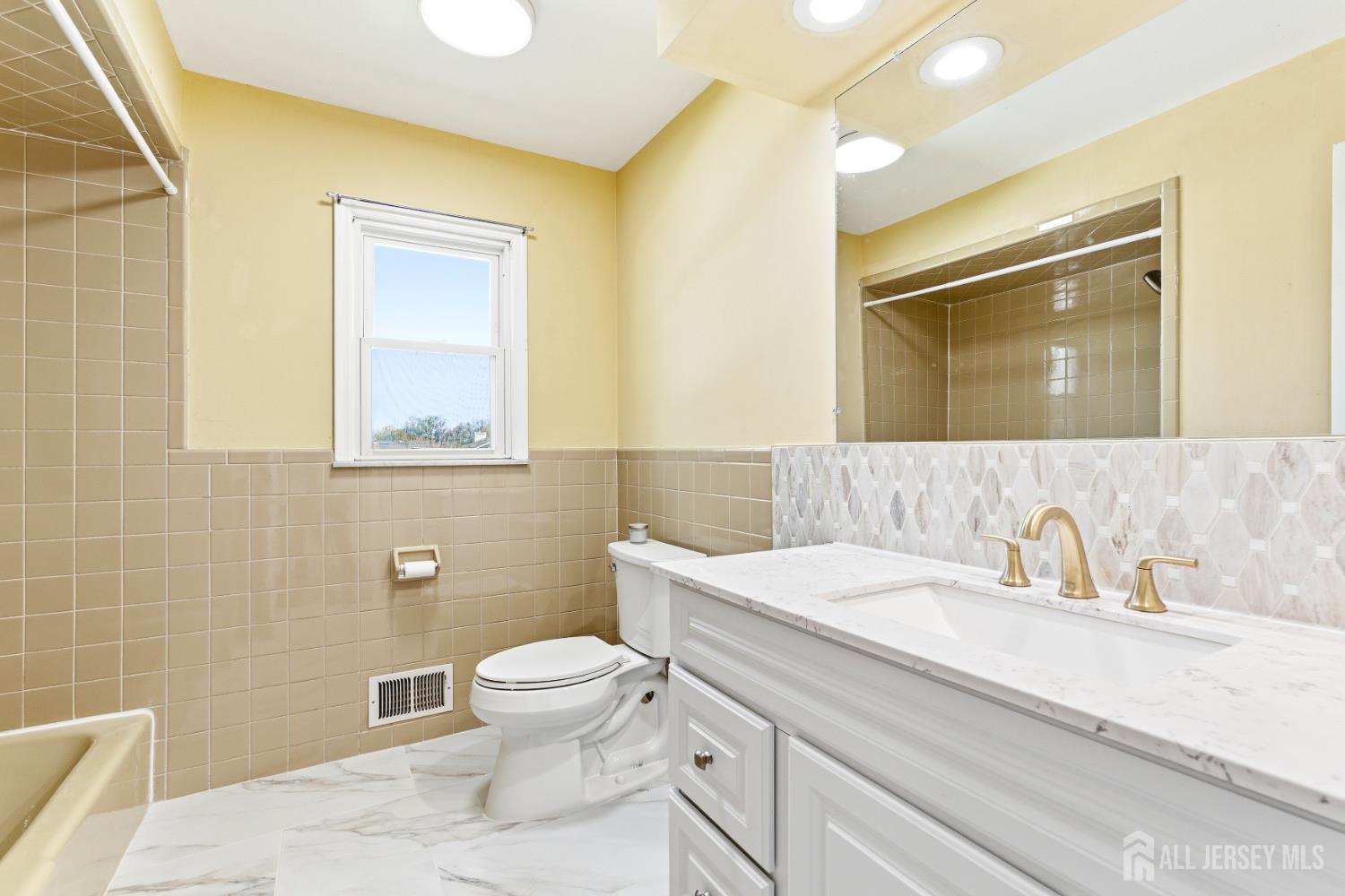 7 Oberlin Court Edison, NJ 08820 - Photo 33 of 45 a bathroom with a sink a toilet and a mirror