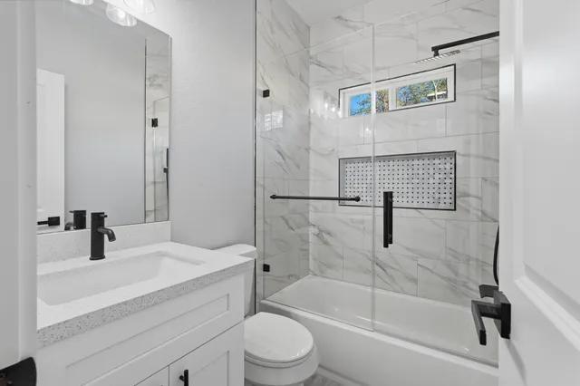 a bathroom with a sink a toilet and a bathtub