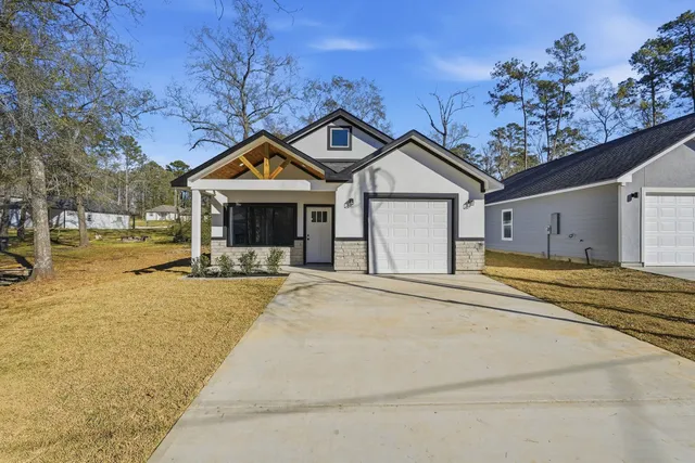 a front view of a house with a yard table and chairs