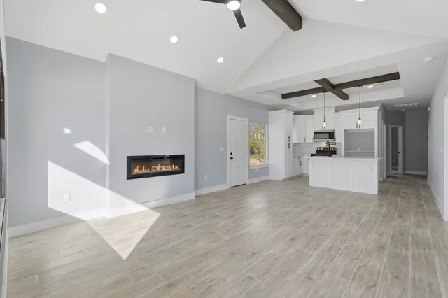 a view of a kitchen with a sink and a refrigerator