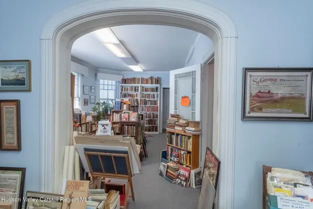 a living room with lots of furniture and clothes