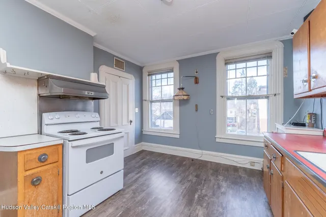 a view of a room with wooden floor