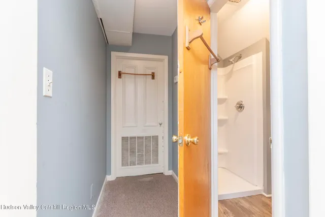a view of a room with wooden floor and windows