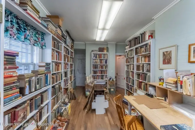 a work room with furniture and a book shelf