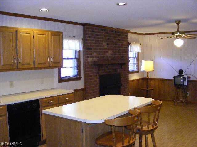 3301 Oak Ridge Road Summerfield, NC 27358 - Photo 4 of 8 Other. Looking from kitchen into dining area with masonry fireplace.