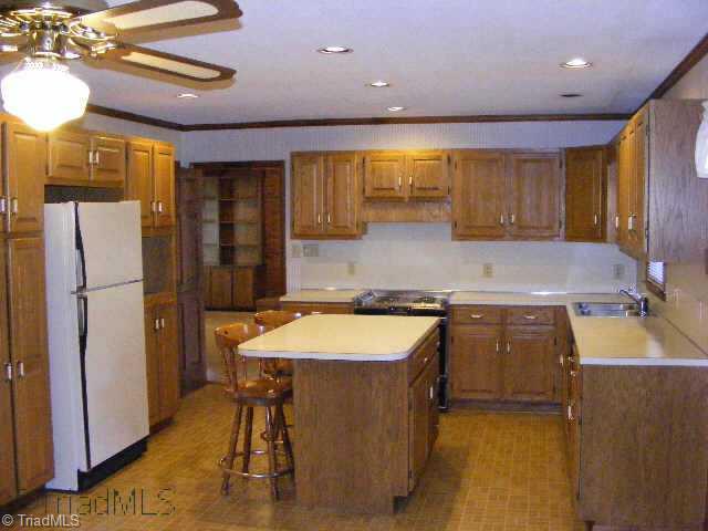 3301 Oak Ridge Road Summerfield, NC 27358 - Photo 6 of 8 Other. Kitchen showing island, custom oak cabinets, and recessed lighting.